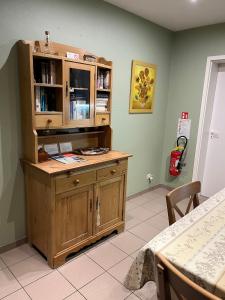 a large wooden cabinet in a room with a table at Casa Brugensis holiday home in historic center of Bruges in Bruges