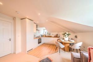 a kitchen and dining room with a table and chairs at Top Floor - Pavilion View Apartment in Buxton