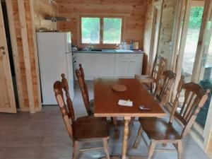 a kitchen and dining room with a table and chairs at Chalet Vosges in Colroy-la-Grande