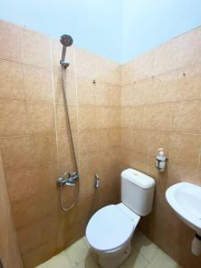 a bathroom with a shower with a toilet and a sink at NamRoom at Tangki Lio in Jakarta