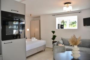 a living room with a bed and a couch at Apartments Toma in Novalja