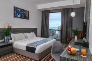 Postel nebo postele na pokoji v ubytování Bahang Bay Hotel