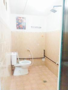 a bathroom with a white toilet in a room at D'boss Homestay Sandakan in Sandakan