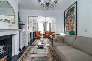 a living room with a couch and a fireplace at 6 Bedroom Refurbished Georgian House Close To Sea & Garden Ramsgate in Ramsgate