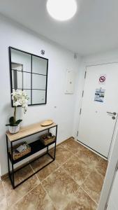 a room with a table and a mirror on the wall at Altos de Jerez & Parking Privado in Jerez de la Frontera