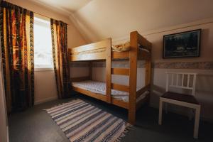 a bedroom with two bunk beds with a cat sleeping on them at Hamnøy Horizon Lodge in Moskenes