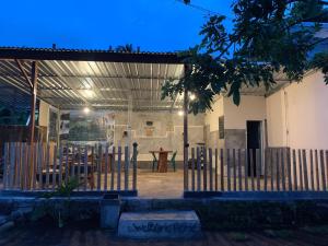 a building with a table and chairs inside of it at Iza home stay in Senaru