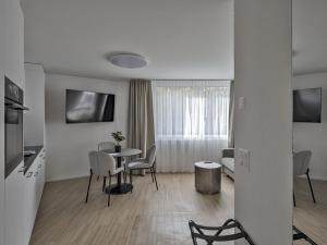 Sjónvarps- og/eða afþreyingartæki á MOOI Apartments Grenchen