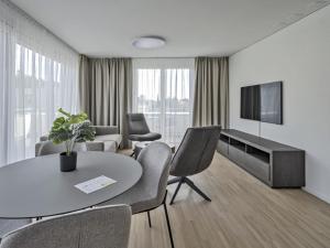 Sjónvarps- og/eða afþreyingartæki á MOOI Apartments Grenchen
