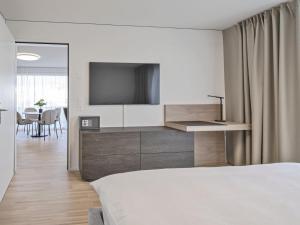 Sjónvarps- og/eða afþreyingartæki á MOOI Apartments Grenchen