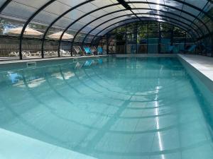 a large swimming pool with a domed ceiling at Camping du Chêne - proche de Nantes in Saint-Julien-de-Concelles
