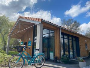 a blue bike parked in front of a building at Camping du Chêne - proche de Nantes in Saint-Julien-de-Concelles
