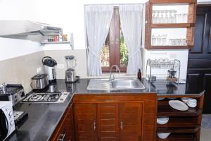a kitchen with a sink and a stove at Baan Fah Sai in Koh Phangan