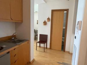 a kitchen with a sink and a chair next to a door at Garibaldi in Trapani