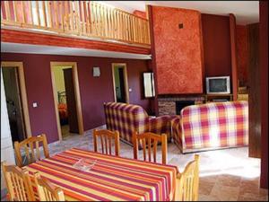 a living room with a table and a couch at La Venta Vieja de Langre in Langre