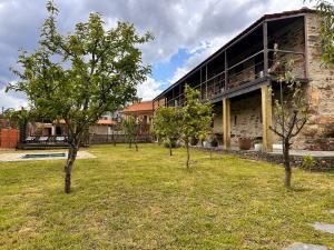 a group of trees in front of a building at Casa do Porco - Farm Stay & Spa no Douro in Melres +261 photos