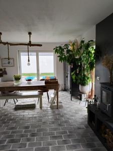 a living room with a table and potted plants at Unieke landelijke woning met zwembad in Kranenburg