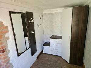 a bathroom with a sink and a mirror on the wall at Ferienwohnung Hanni in Gräfenhainichen