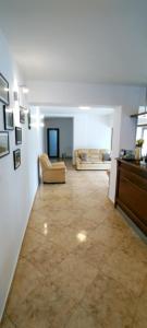a large living room with a couch and a table at Pensiunea Bocca Del Rio in Gura Râului +37 photos