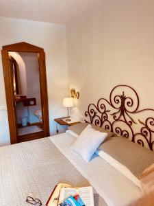a bedroom with a large bed with a wooden headboard at B&B Pichler Casa in Castello di Fiemme +169 photos