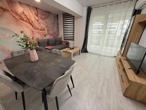 a living room with a table and a couch at Evo apartments VRT No 1 in Şelimbăr +6 photos