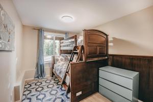 a bedroom with a bunk bed and a dresser at Mt, Baker Rim Cabin 80 - Hot Tub - Wi-Fi - Bbq in Glacier