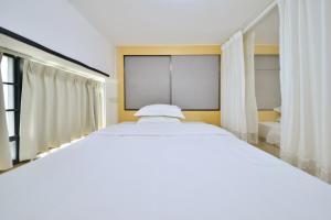 Llit o llits en una habitació de Dabaizhijia Executive Apartment Bantian Huawei Branch