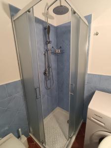 a shower with a glass door in a bathroom at Raggio di Sole in Campofelice di Roccella
