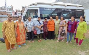 a group of women standing in front of a bus at LD Guest House, Ayodhya in Ayodhya