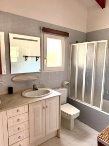 a bathroom with a sink and a toilet at Villa Cala Lanuza in Alicante +26 photos