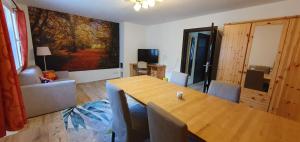 a living room with a wooden table and a dining room at Ferienwohnungen 3 Birken in Briesen