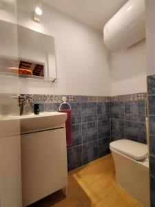 a bathroom with a toilet and a sink at Casa Santísimo in Vejer de la Frontera +23 photos