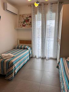 a bedroom with two beds and a window at la bussola gallipoli in Gallipoli