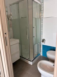 a bathroom with a glass shower and a toilet at la bussola gallipoli in Gallipoli +21 photos