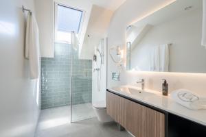 a bathroom with a sink and a toilet and a shower at Cíes Luxury Suitel Areosa 22 in Vigo +139 photos