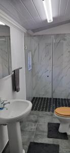 a bathroom with a shower and a sink and a toilet at Strand Overnight - 24 Hour check-in - close to major private hospitals - sleeps 1- 4 guests - self catering - quiet neighborhood - week night low rate for single guest - weekends min 2 nights in Strand +15 photos