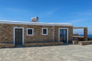 a brick building with a camera on top of it at Rustic Stone House in the Heart of Folegandros in Áno Meriá