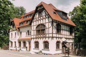 an old building with a red roof at Parkschlösschen Lichtenstein Sachsen in Lichtenstein +7 photos