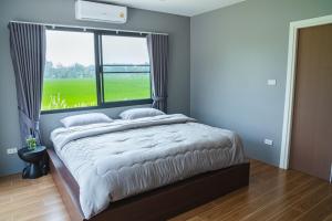 Postel nebo postele na pokoji v ubytování Kirin's House Mae Taeng Chiangmai