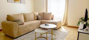 a living room with a couch and a table at Cozy Escape in Ongata Rongai 