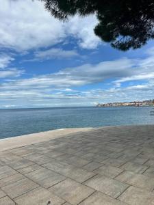 a view of the ocean from a brick walk way at Apartma Studio Enej Piran in Piran