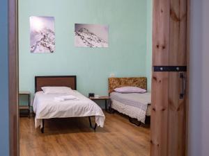 a room with two beds and two pictures on the wall at kutaisi base camp in Kutaisi