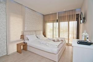 a bedroom with a bed in a room with windows at Christie's Luxury Suites by Dandy Hospitality in Syvota +100 photos