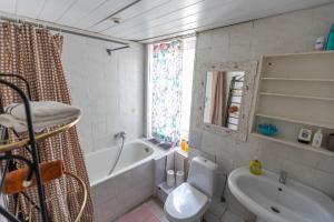 a bathroom with a tub and a toilet and a sink at Baltic Holiday Guest House in Jūrmala +28 photos