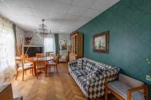 a living room with a couch and a table at Baltic Holiday Guest House in Jūrmala