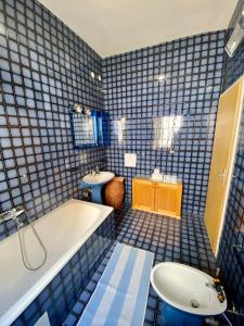 a blue tiled bathroom with a tub and a sink at Lilys Paradise in Orebić +42 photos
