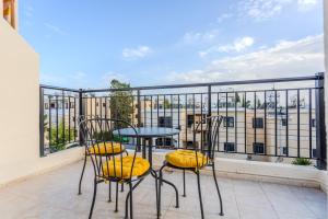 a balcony with a table and chairs on a balcony at AVS Margarita Gardens in Paphos City