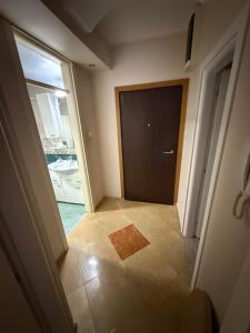an empty hallway with a door in a room at Casa Verde LLS in Budva +14 photos