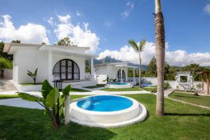 a house with a swimming pool in a yard at Kamaru Villa Kintamani in Kintamani