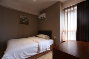 Rúm í herbergi á Chongqing Xiaoshe Yuanmu River View Guesthouse Jiefangbei Hongyadong Branch